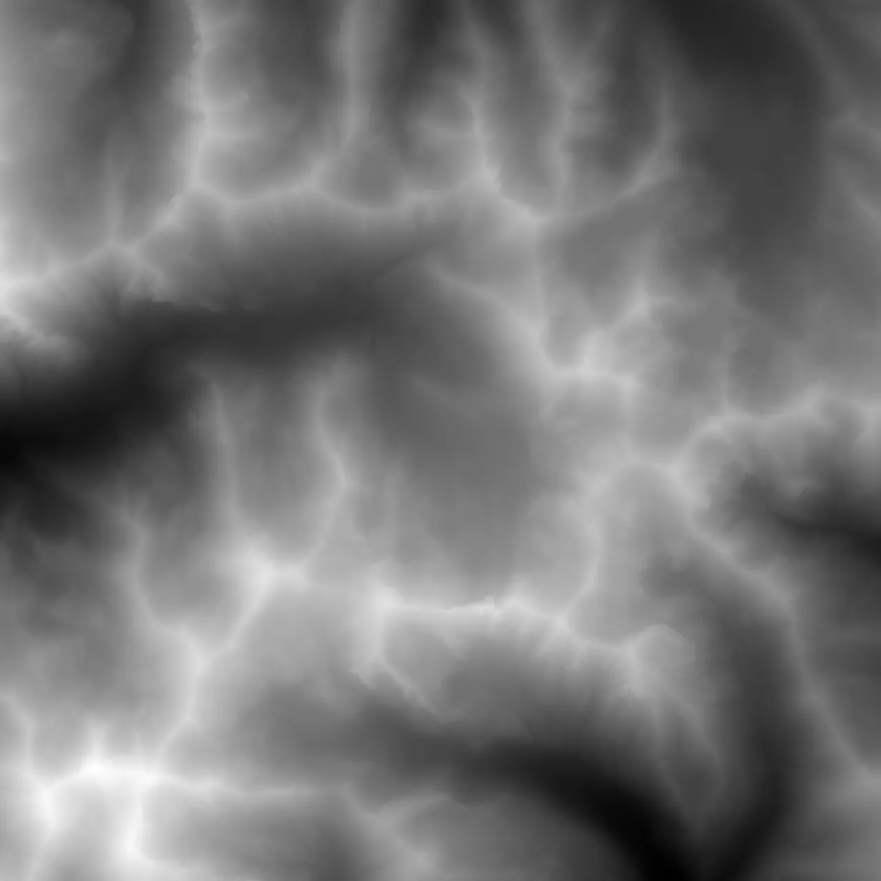A greyscale heightfield of the same range, elevation read as brightness: ridgelines picked out white, valley floors falling away to near black.